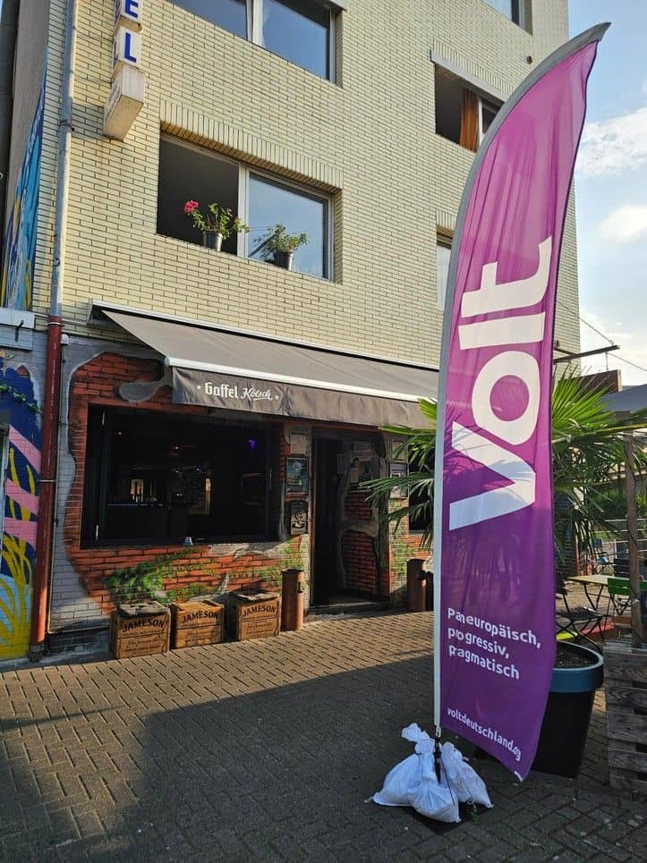 Außenansicht eines Restaurants mit Vortafel und Flagge in Berlin.